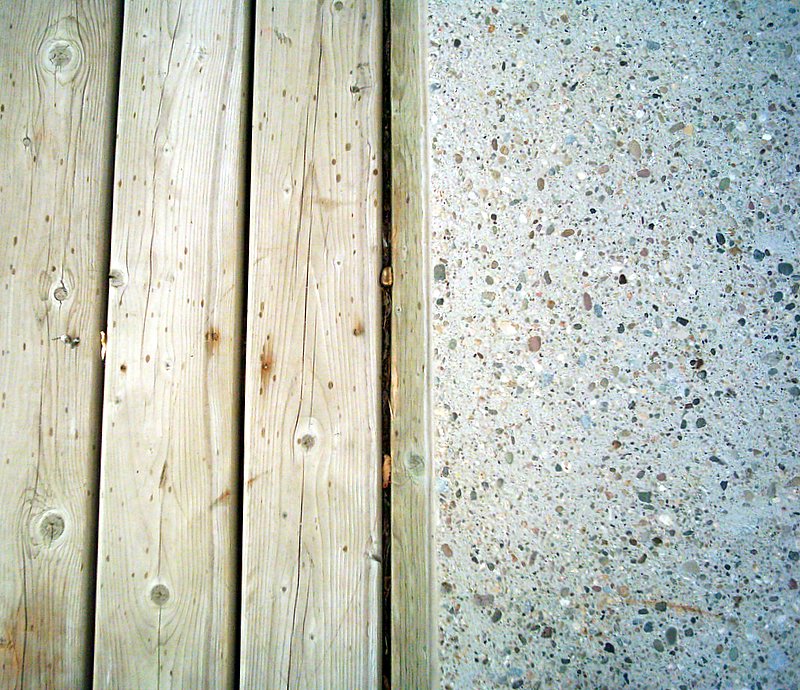 Concrete patio or porch slab edge with visible separation and uneven settling
