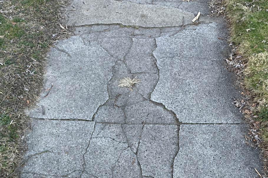 Uneven sidewalk slab creating a trip hazard